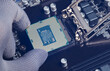 © Supatman - Computer technology hardware concept. Repairman computer Installation CPU on socket of the motherboard in laboratory. CPU computer processor shallow focus. maintenance or repair. computer upgrade,