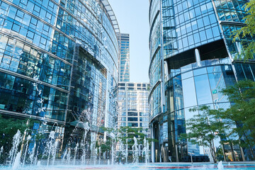 Detail of skyscraper office buildings with glass facades. Modern urban architecture. High rise building in downtown of Warsaw city