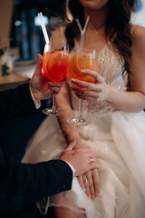 Wall Mural - bride and groom drinking champagne in the restaurant