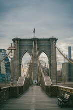 Brooklyn Bridge With American Flag In City
