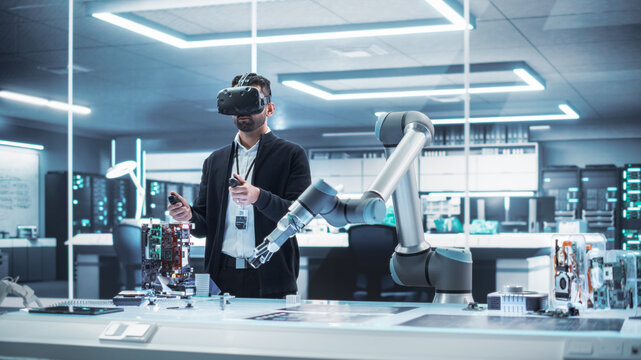 Robotics Engineer Operating a Futuristic Robotic Arm, Using a Virtual Reality Headset and Controllers to Perform Tasks. Work in Research and Development High Tech Facility Startup.