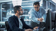 © Gorodenkoff - Two Industrial Engineers Discussing Work Projects, Talk and Use Desktop Computer in Robotics Startup Facility. Specialists and Professionals Researching and Developing High Tech Robotics Equipment.