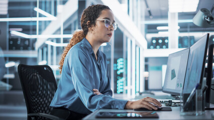 Wall Mural - Happy Multiethnic Female Industrial Engineer Developing 3D Model of a Circuit Motherboard on Computer CAD Software in a Startup Facility. Modern Technological Research and Development Center.