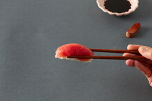 Crop Person With Sashimi In Chopsticks