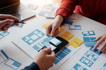 designer, programmers, developers of mobile applications work together to invent a modern mobile app