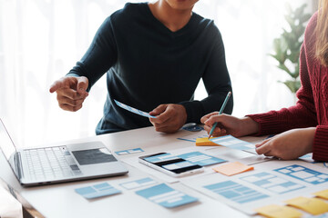 Designer, programmers, developers of mobile applications work together to invent a modern mobile application system.