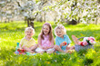 © famveldman - Family picnic in spring park. Kids eating outdoors