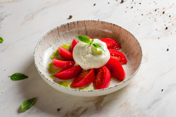 Canvas Print - Salad with buratta cheese,basil and tomatoes on bowl on white marble table