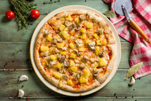 Pizza Hawaiian With Pineapple And Chicken Top View On Green Wooden Table