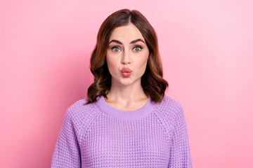 Wall Mural - Portrait of satisfied funny positive girl with curly hairdo wear violet pullover pouted lips kiss isolated on pink color background