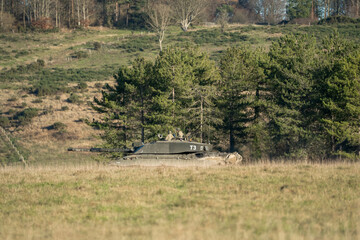 commander and gunner directing action in a British army FV4034 Challenger 2 ii main battle tank on a military combat exercise, Wiltshire UK