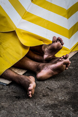 Two street vendors sleeping on the floor after Carnival night