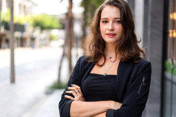 Beautiful happy confident businesswoman smart looking at camara while sitting on office workplace desk.Young creative coworkers business people working and planning.