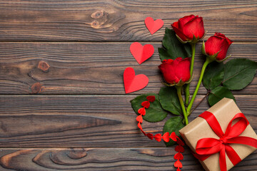 Valentine's day composition with rose flower, red heart and gift boxes on table. mother day and birthday greeting, copy space, top view