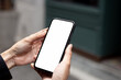 © panitan - cell phone blank white screen mockup.hand holding texting using mobile on desk at office.background empty space for advertise.work people contact marketing business,technology