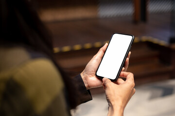 cell phone blank white screen mockup.hand holding texting using mobile on desk at office.background 