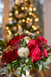Bridal rose bouquet for Christmas wedding in front of Christmas tree