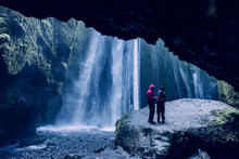 Lovers in front of the secret falls, Iceland.