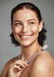 © K Abrahams/peopleimages.com - Toothbrush, woman brushing teeth and dental wellness with hygiene, cleaning and teeth whitening. Face of a happy female with a smile for oral health, healthy mouth and self care on studio background