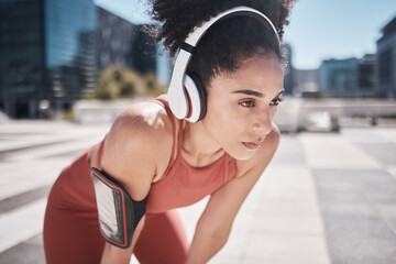 Canvas Print - Phone, fitness app and headphones, tired black woman runner stop to relax or breathe on city workout run. Health, urban training and wellness, woman on break from running exercise and streaming music