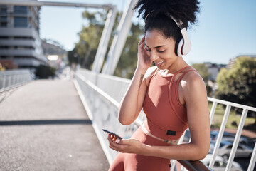 Sticker - Music headphones, fitness and black woman with phone for social media in city. Exercise, sports and female athlete streaming radio or podcast on 5g mobile smartphone after training outdoors on street