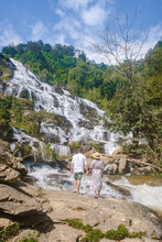 Couple Visits Mae Ya Waterfall Doi Inthanon National Park Thailand Chiang Mai. Asian Women And Caucasian Men Visit A Waterfall