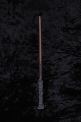 Wall Mural - wooden magic wand on black velvet