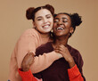 © S Fanti/peopleimages.com - Lesbian, couple hug with young women and happy with fashion and marketing, love and fun together against studio background. Lgbtq community, gen z and freedom with style and lgbt people with pride