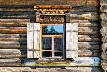 Canvas Print - Windows of traditional russian log house with carved wooden trim