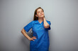 Tired doctor woman or nurse standing with hand on neck, closed eyes. Isolated portrait of female medical worker.