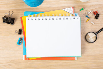 Wall Mural - Notebook mockup with school stationery on a wooden table. back to school concept. Blank notepad with copy space. list of goals and plans for new year 2023