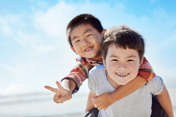 Poster - Beach, peace sign and Asian children hug on Japan travel vacation for calm, freedom and outdoor nature. Blue sky, ocean sea or happy youth portrait of fun kids or friends on holiday playing piggyback