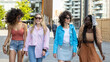 © MandriaPix - Four girls teenagers of Generation Z in the city, young women having fun walking in the city