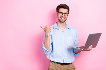 Aufkleber - Photo of positive successful man user demonstrate empty space recommend buy modern device netbook isolated on pink color background
