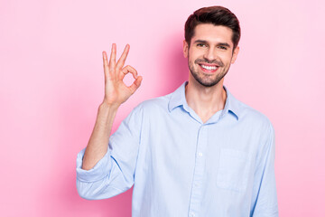 Sticker - Photo of positive glad man wear stylish clothes arm demonstrate okey symbol done finish task empty space isolated on pink color background