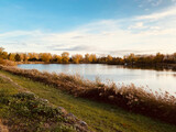 Fototapeta Zachód słońca - Lake view. Near Lake Buzerens, Bram, France. Reflections of the natural landscape in the water.