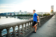 Sporty Man Exercising On Bridge In City