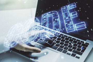 Wall Mural - creative code word sign and hands typing on laptop on background, international software development