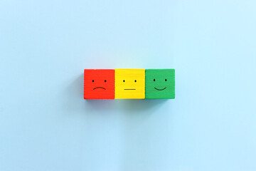 Wall Mural - Top view image of cubes with happy and sad face. concept of happiness emotion and satisfaction