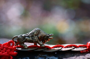 Wall Mural - Metal bull figurine and Chinese Feng Shui coins.