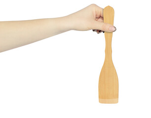 wooden kitchen spatula in hand isolated from background, concept of hand over or throw away wooden kitchen spatula