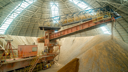 Industrial plant top view. Cement plant, raw material processing equipment. Manufactory with technological equipment. Sand destined to the manufacture of cement in a quarry.