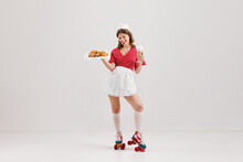 Emotional Young Woman, Retro Waitress In American Fashion Style Of 70s, 80s Uniform Posing Over Light Studio Background. Comic Photography Style