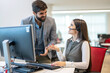 © Bojan - Young hands-free customer support operator woman getting advices from her executive director at office