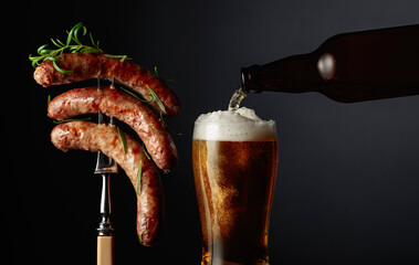 Wall Mural - Beer and grilled sausages with rosemary.