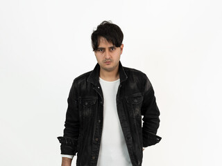 Closeup studio photo of brown skinned young adult model wearing black jacket with messy hairstyle. Concept of fashion and stylish clothing.