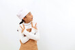 © ArvStd - Happy little girl in chef uniform pointing both sides and looking at empty space. Isolated on white background