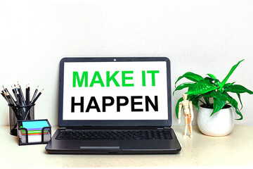 Wall Mural - On the desktop is a potted plant, stationery and an open laptop with the text MAKE IT HAPPEN on the screen. Home Office.