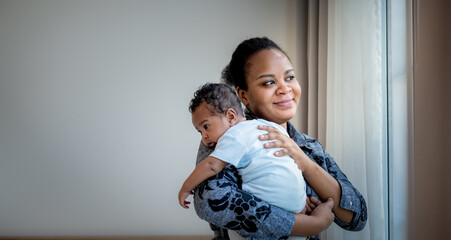 African family,  2-month-old baby newborn son is half-African halt-Thai on mother's shoulder, they are happy together. to baby newborn and family concept.