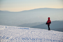 Scenic Winter Mountains Landscape With Girl In Red Jacket Looking Far Away